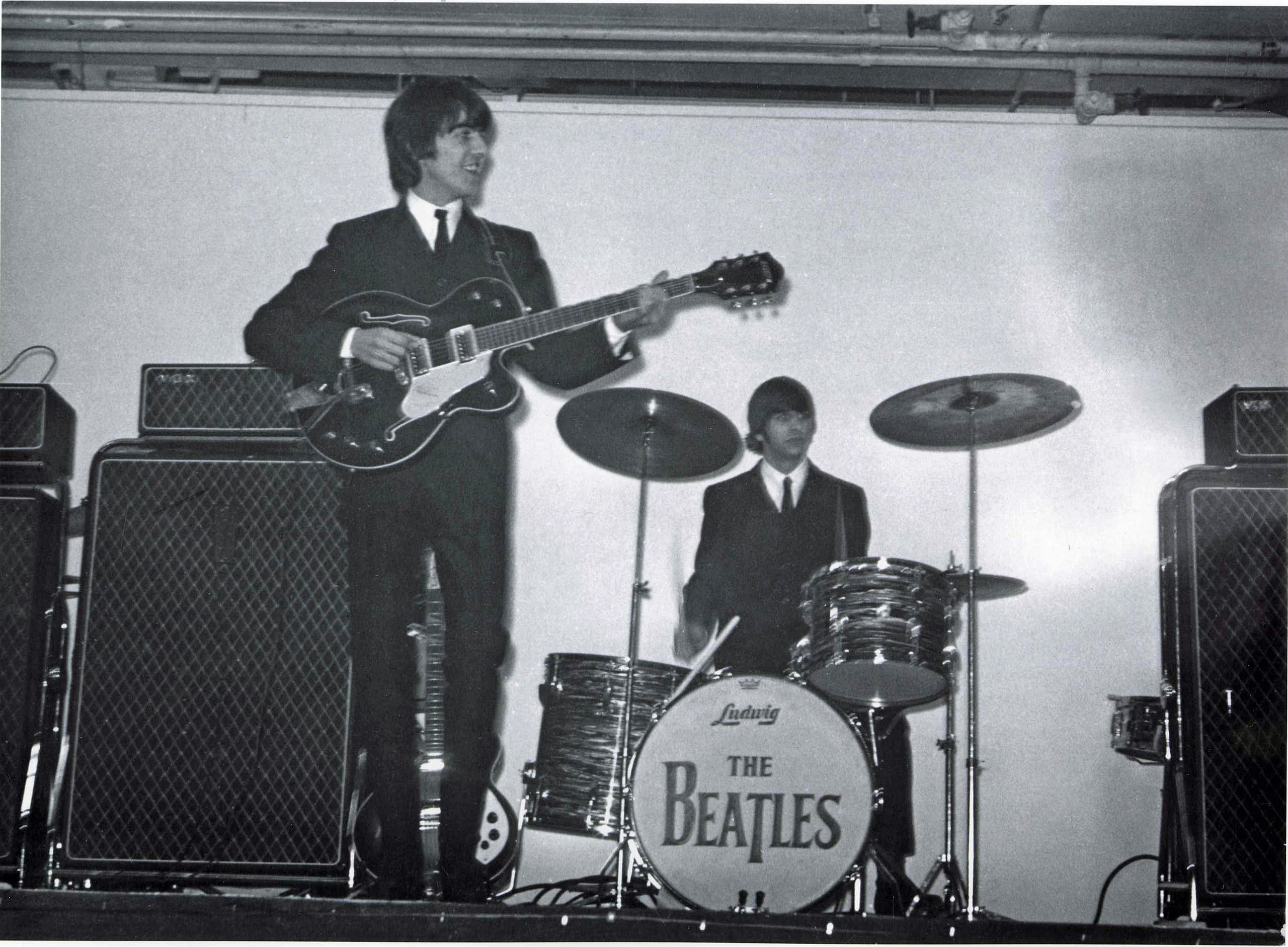 Harrison (left) and Ringo Starr (right) performing at the King's Hall in Belfast, 1964