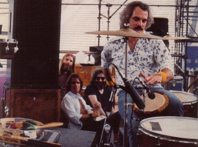Grateful Dead members in the early 1980s: Brent Mydland, Bob Weir, and Jerry Garcia watch Bill Kreutzmann
