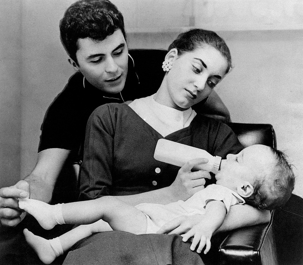 American actor and singer James Darren (James Ercolani) looking at his wife Gloria Terlitsky holding their son Jim Moret in her arms, taken in the 1950s