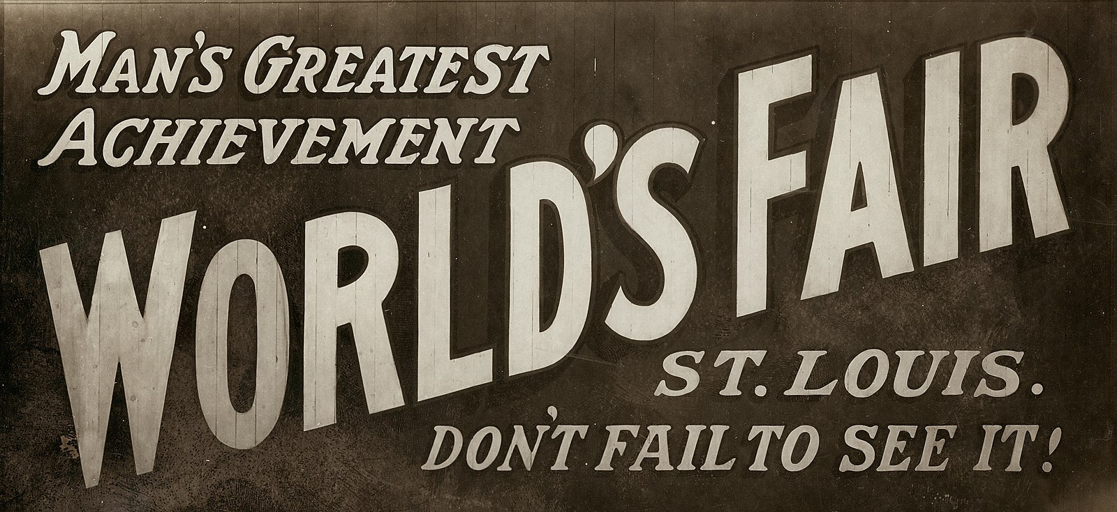 "Man's Greatest Achievement--Worlds Fair--St. Louis--Don't Fail to See It." Billboard at State and Washington Streets in Minneapolis, Minnesota advertising the 1904 World's Fair in St. Louis.