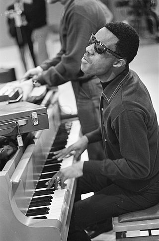 Stevie Wonder practicing on piano for his performance on Dutch television image