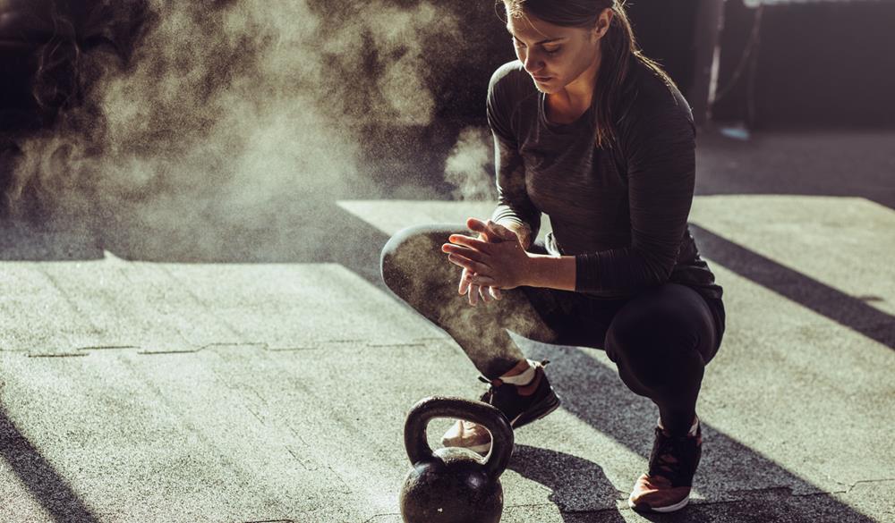 Woman exercising with a kettle ball
