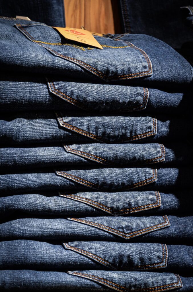 A pile of blue jeans image