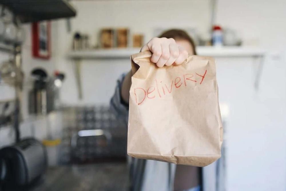 Delivery written on a paper bag