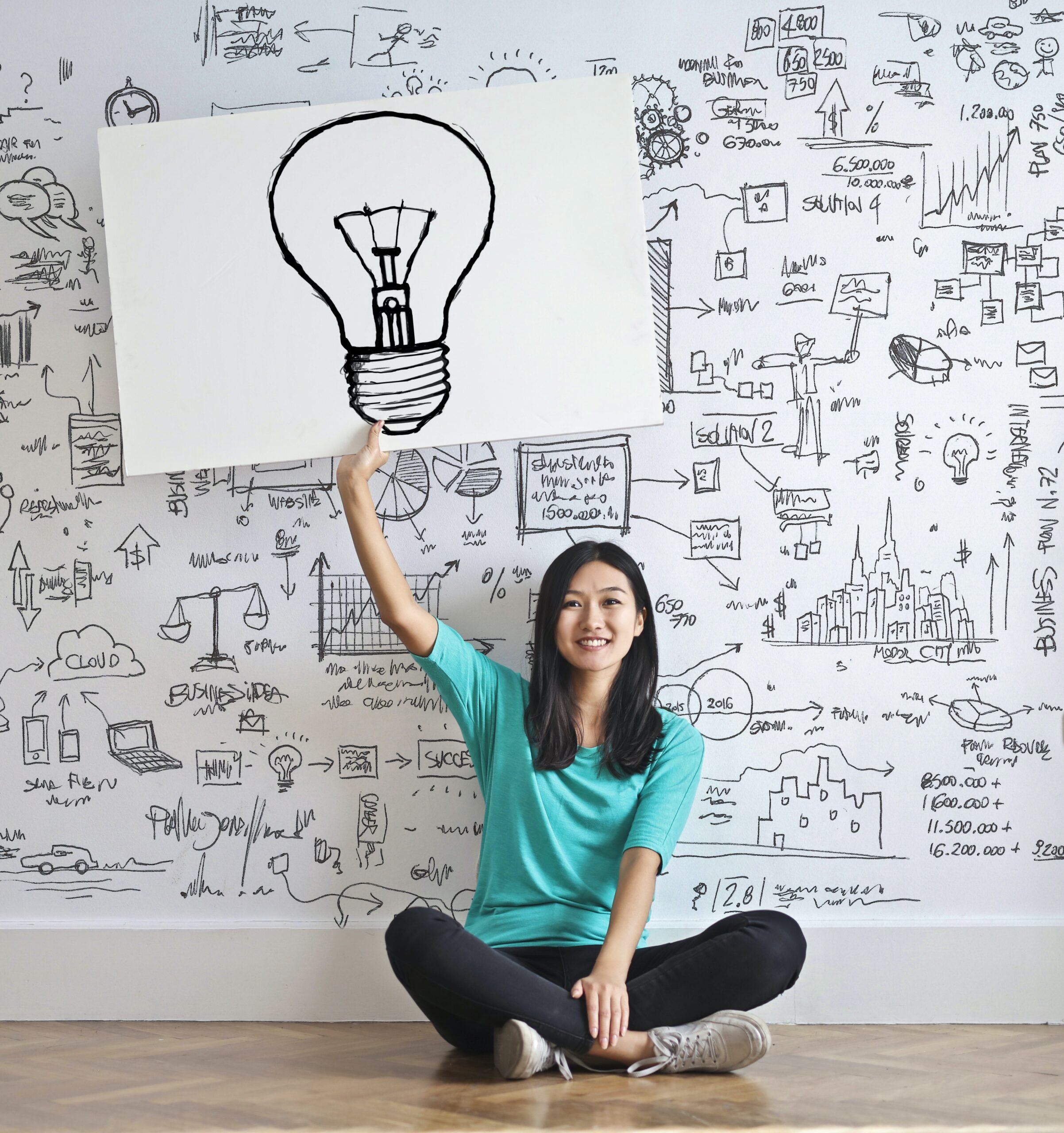 A woman holding up a lightbulb image