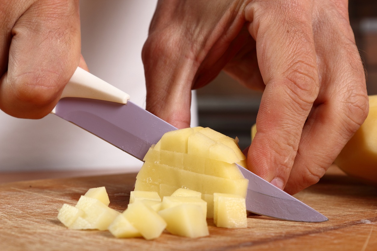 Chopped potatoes with chopping board and knife