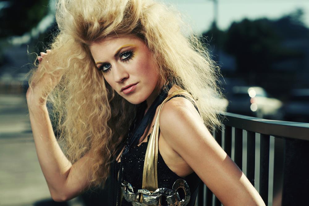 Retro big hair blonde in gold and black outfit