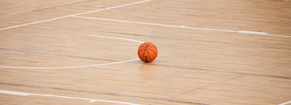 A basketball lying on the basketball court