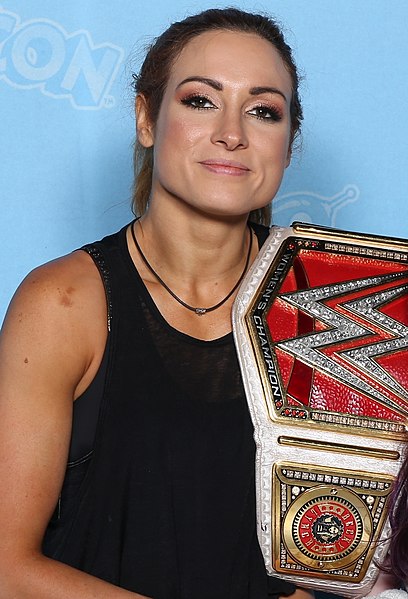 Becky Lynch holding her WWE championship belt
