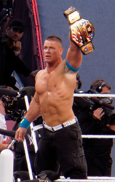 John Cena holding up a championship belt