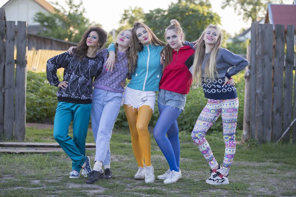 Women wearing neon and colorful printed leggings in 80s style