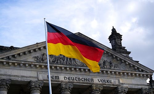 A German flag in front of a building