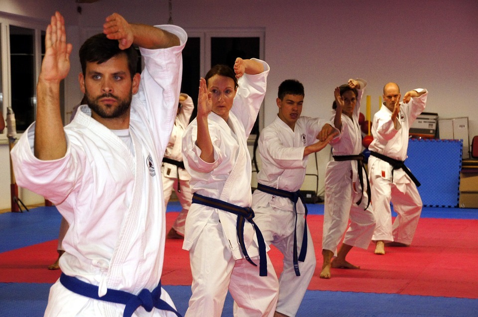 Karate players striking a karate move during practice