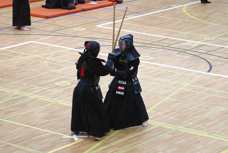 Two Kendo players fighting in a match