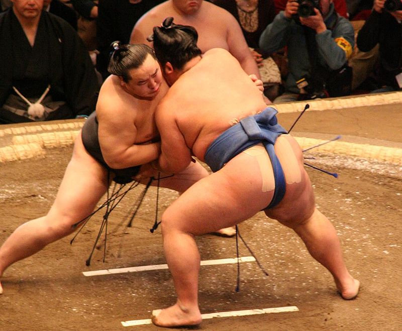 Two sumo players fighting during a match