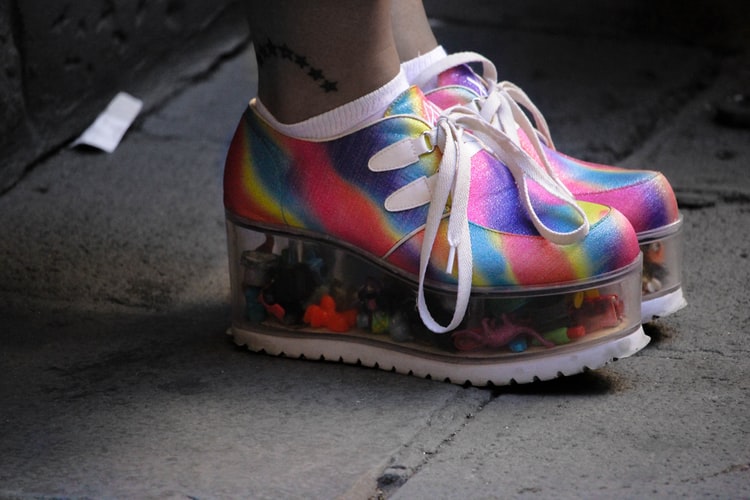 rainbow colored platform shoes with plastic toys inside the heel