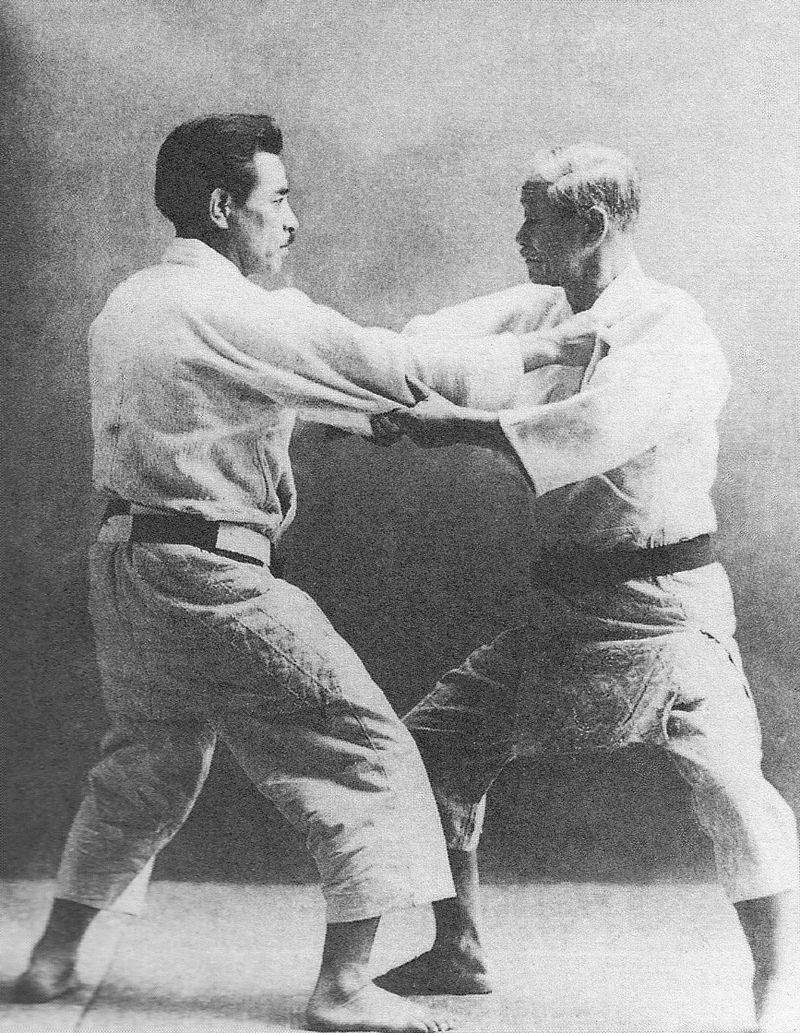 two judo players fighting in a match