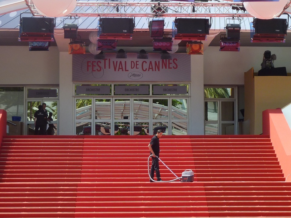 a man cleaning the stairs to the entrance of Festival de Cannes