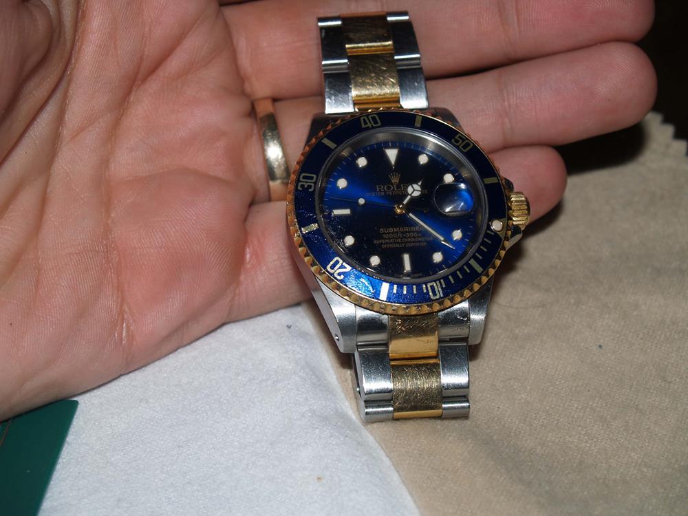 Person holding a Rolex Submariner 16613