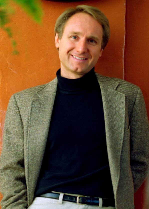 Dan Brown in front of a brown wall image