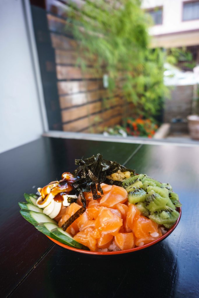 Kiwi, cucumber, fish meat, banana, and nori salad on a plate
