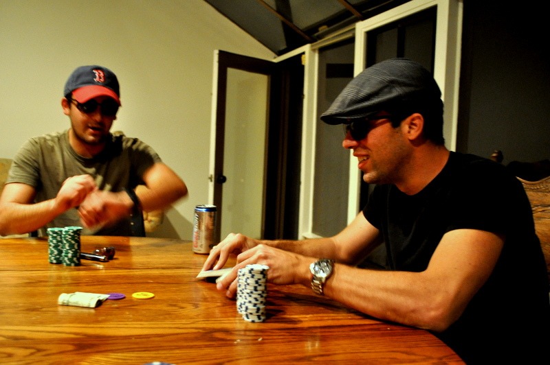 two men playing poker with sunglasses on