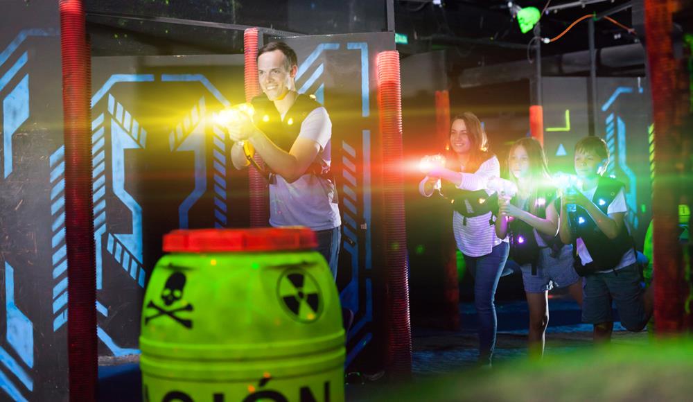 Whole family playing laser tag