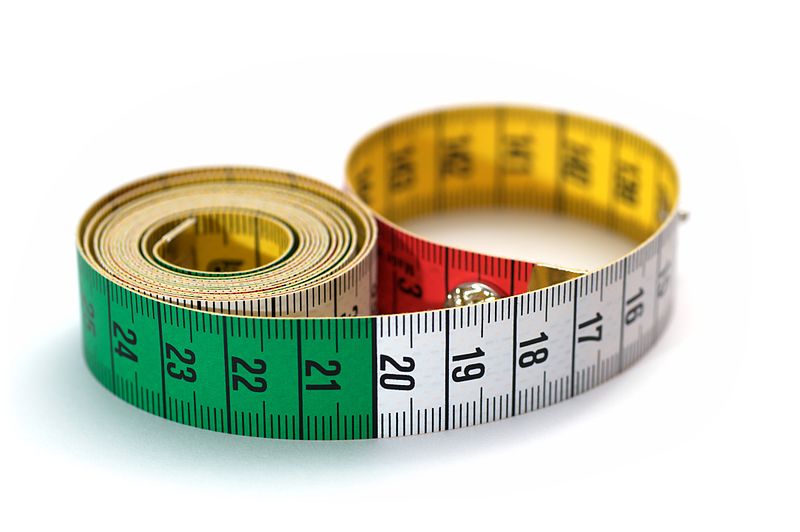 a tape measure with multicolor measurements image