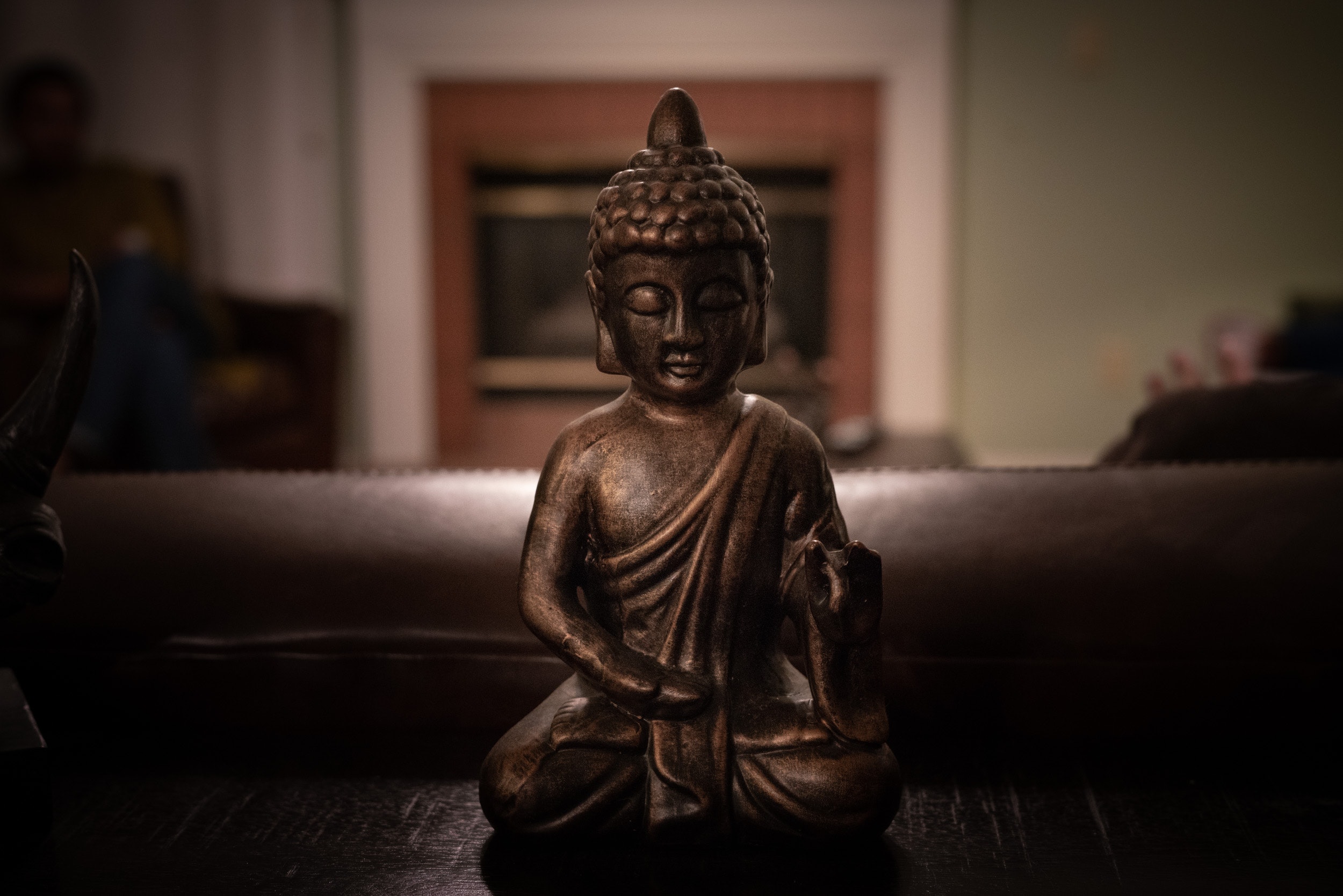 brass Buddha figurine on a black surface image