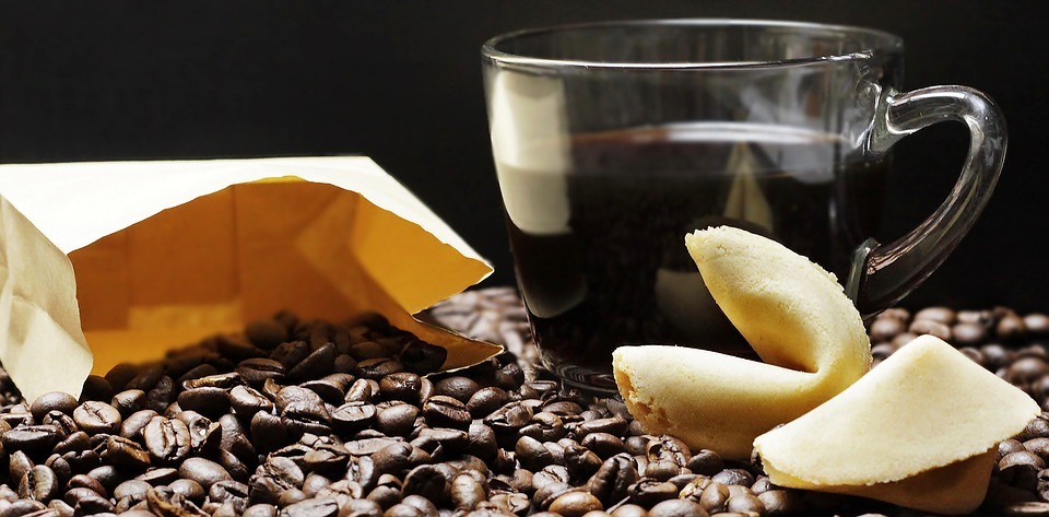 coffee beans, a cup of coffee and fortune cookies