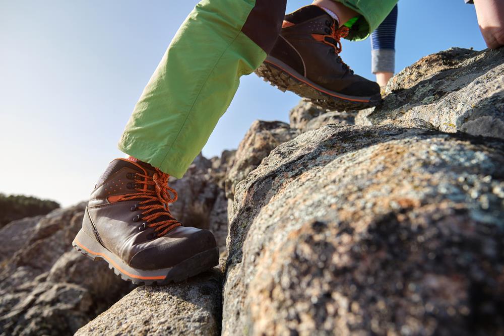 Hiker climbing over rocks