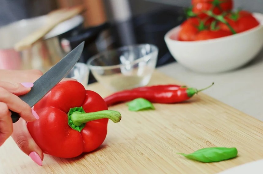 person chopping bell peppers