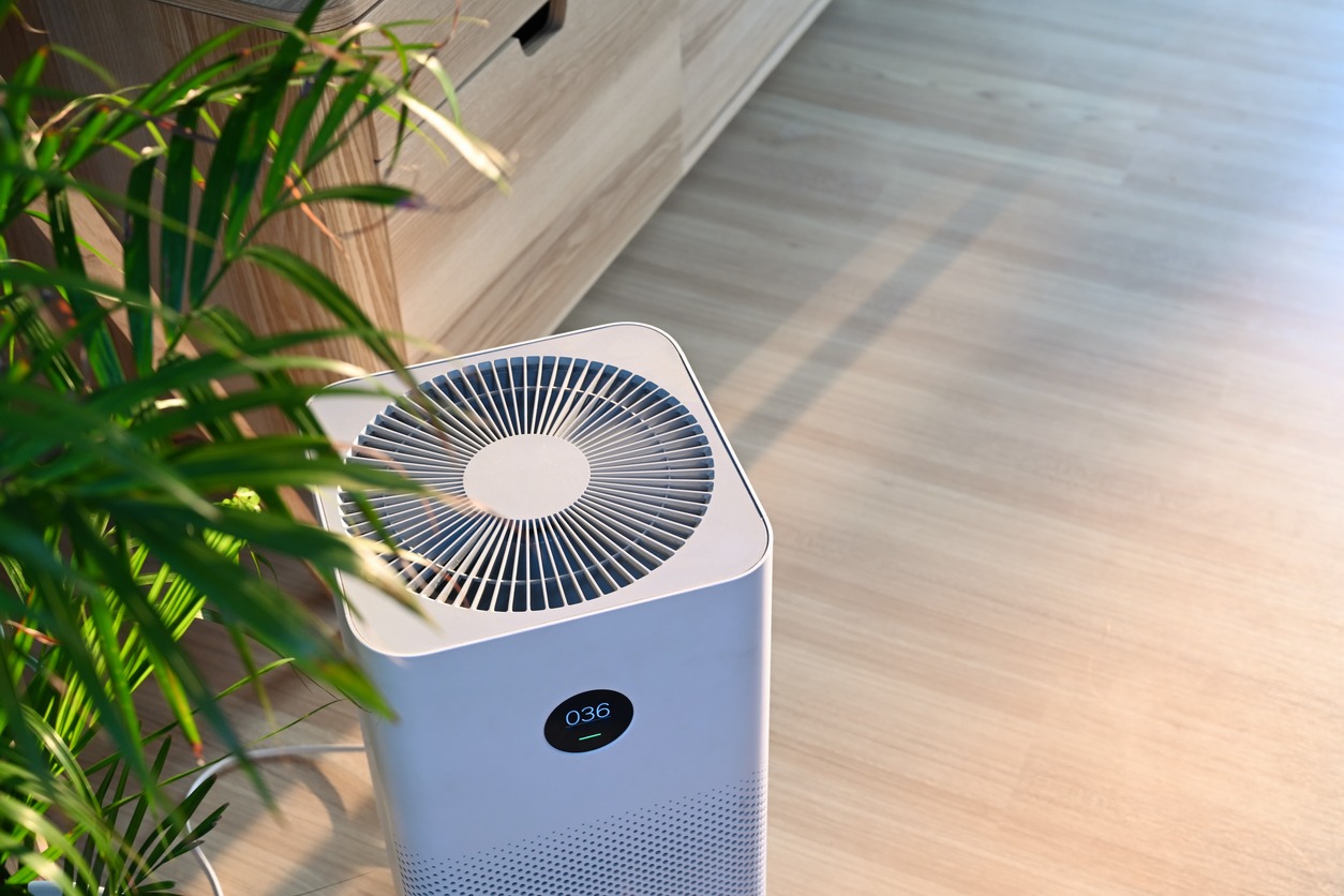 Air purifier on wooden floor in comfortable home