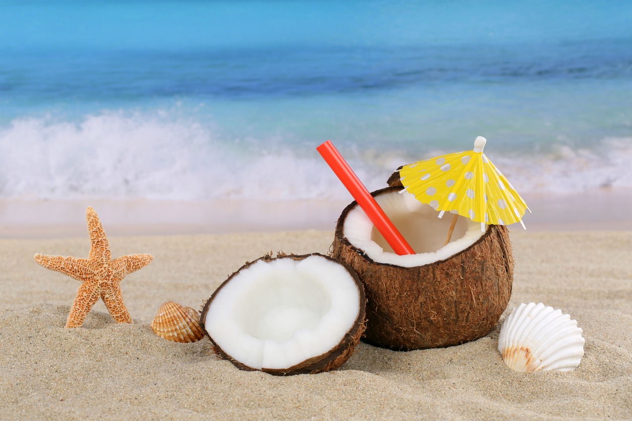 Coconut fruit cocktail drink in summer on the beach and sea with copy space
