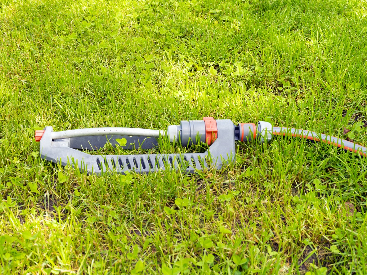 Lawn watering system. Irrigation of green grass. Sprinkler for the garden