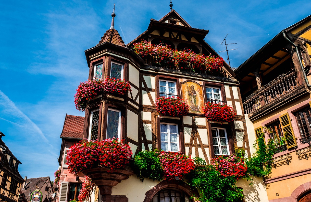 Old buildings decorated with flowers in the village of Kaysersberg in Alsace, France
