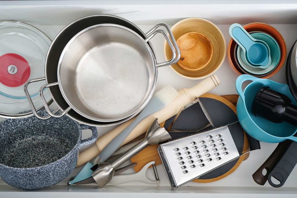 Open drawer with different utensils in the kitchen, flat lay
