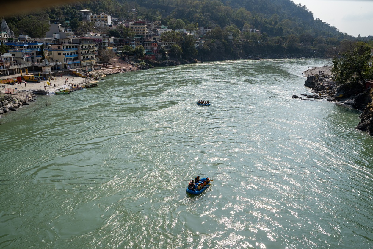 Rishikesh, India - February 22, 2020: View of the Ganges River as rafting boat tours venture down the river