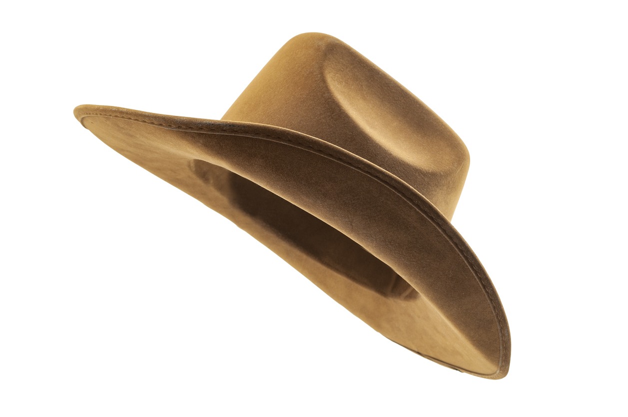 Rodeo horse rider, wild west culture, Americana and American country music concept theme with a side view of a brown leather cowboy hat isolated on a white background with clip-path cut out