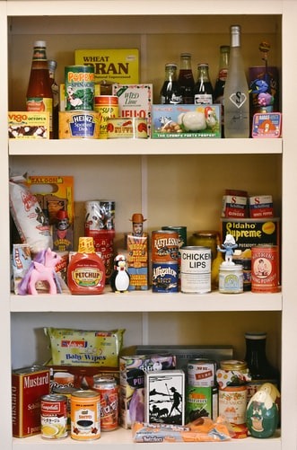 assorted food products on white wooden shelf