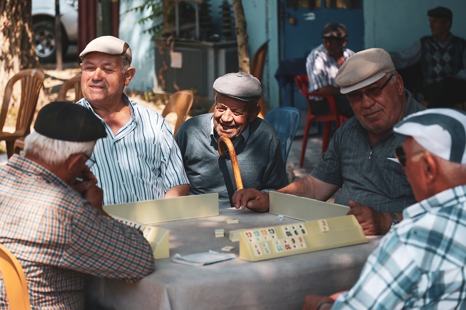 Old men in the street playing a game of tiles