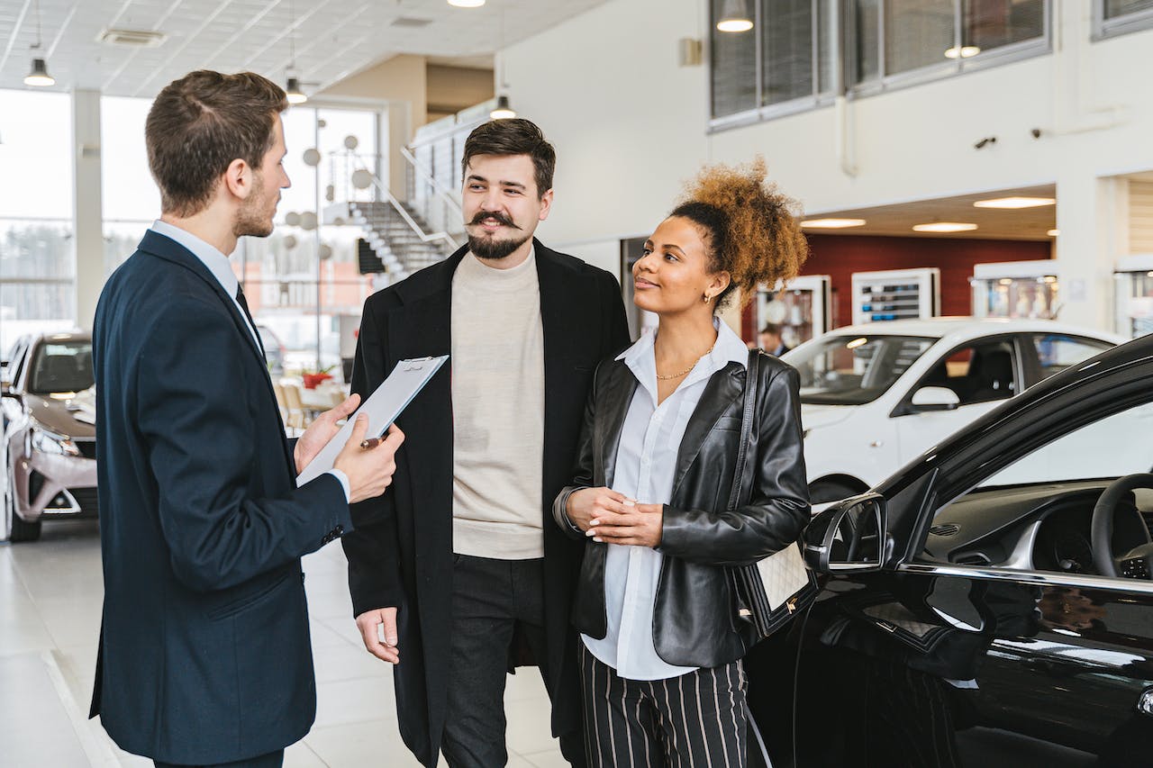 couple buying a car in the dealership