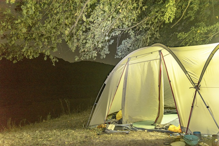 illuminated tent on a summer night, Ukraine. The banks of the Dniester River