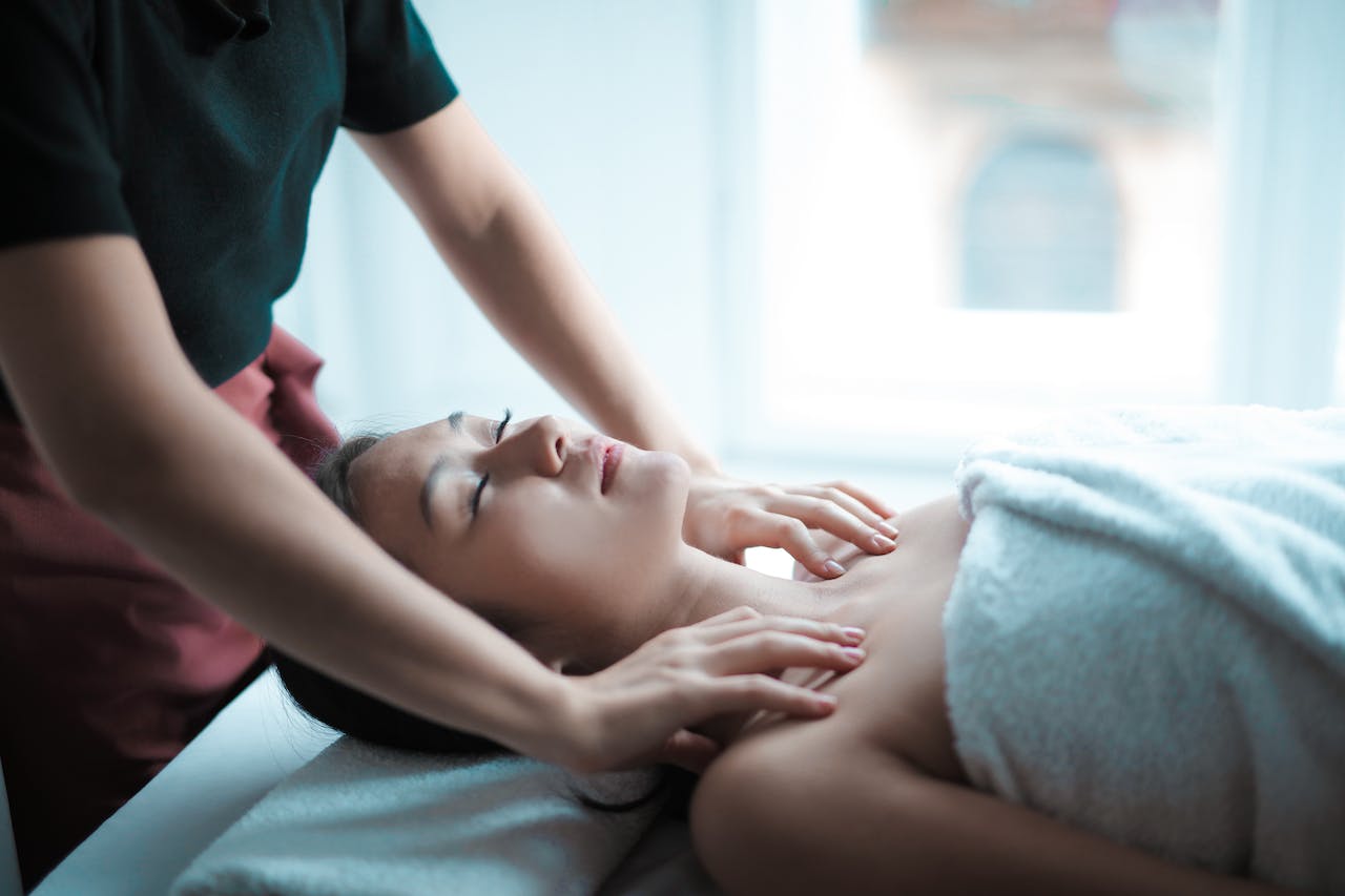 selective focus photo of a woman getting a massage