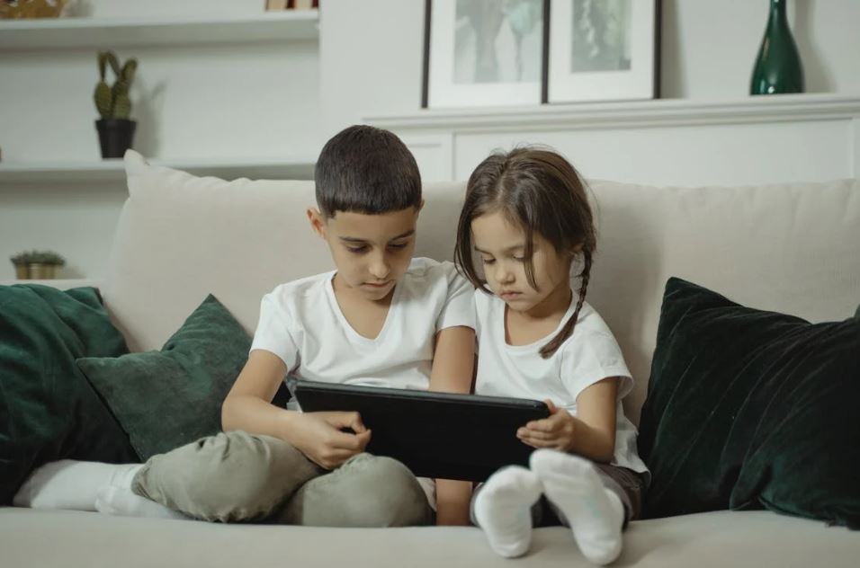 Boy and Girl Watching on the Digital Tablet