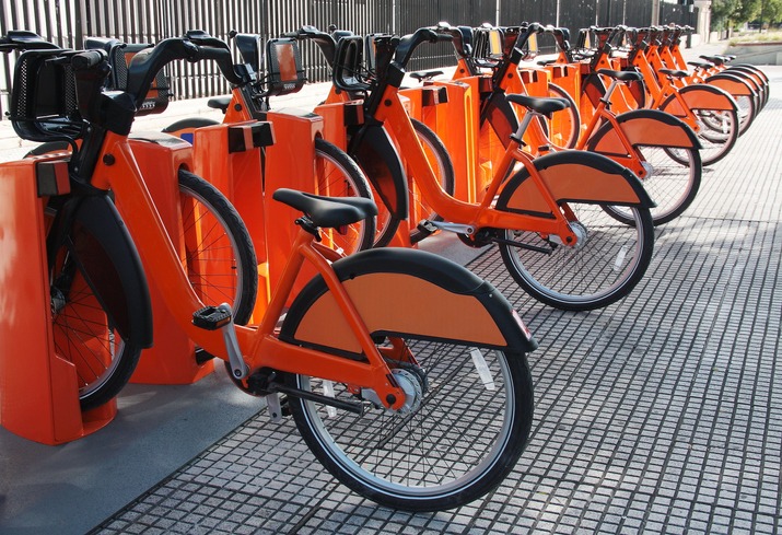 Electric bicycles parked at a bike-sharing station