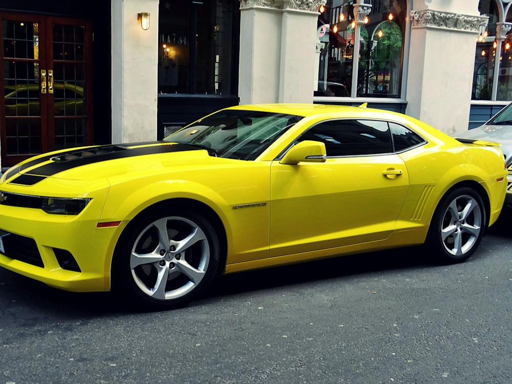 Yellow Chevrolet Camaro Parked Outside of Building