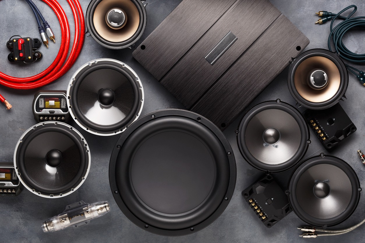 car audio, speakers, subwoofer, and accessories for tuning. Dark background. Top view