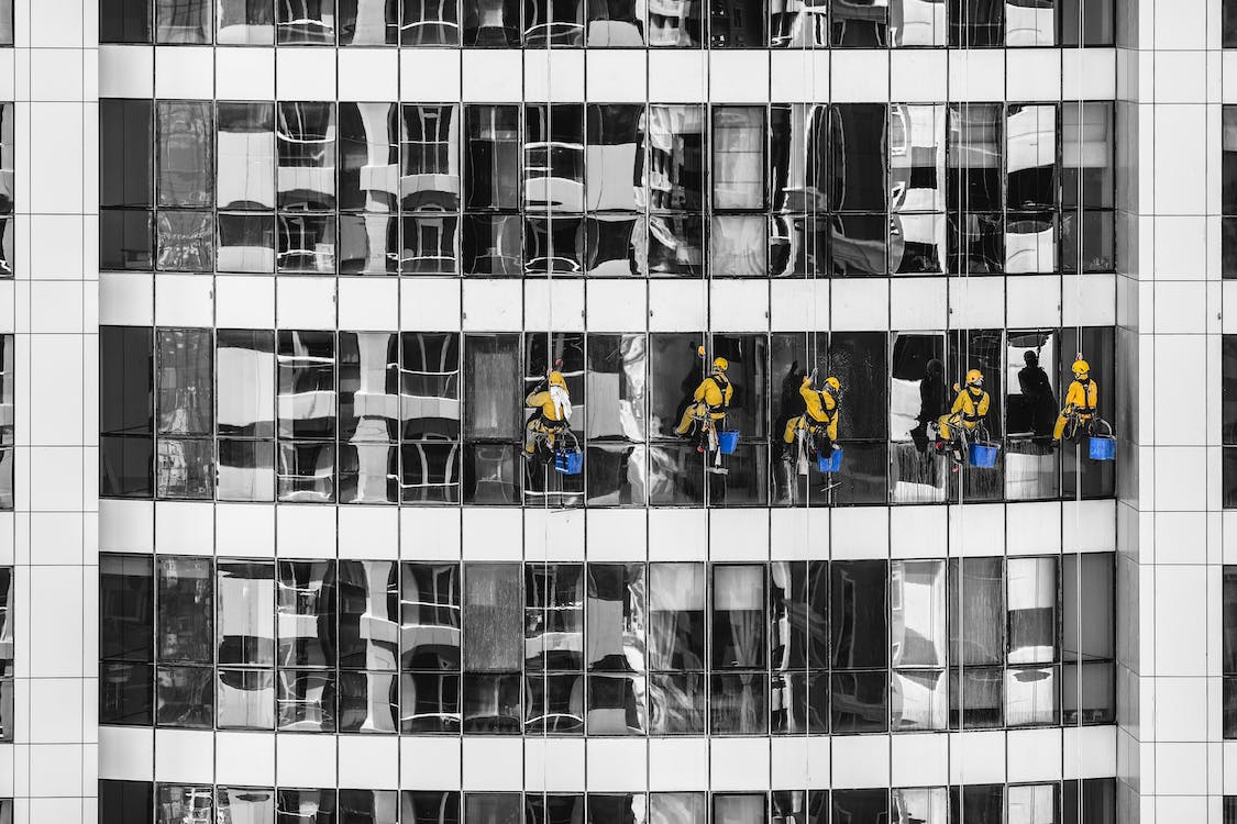 five-person cleaning glass building