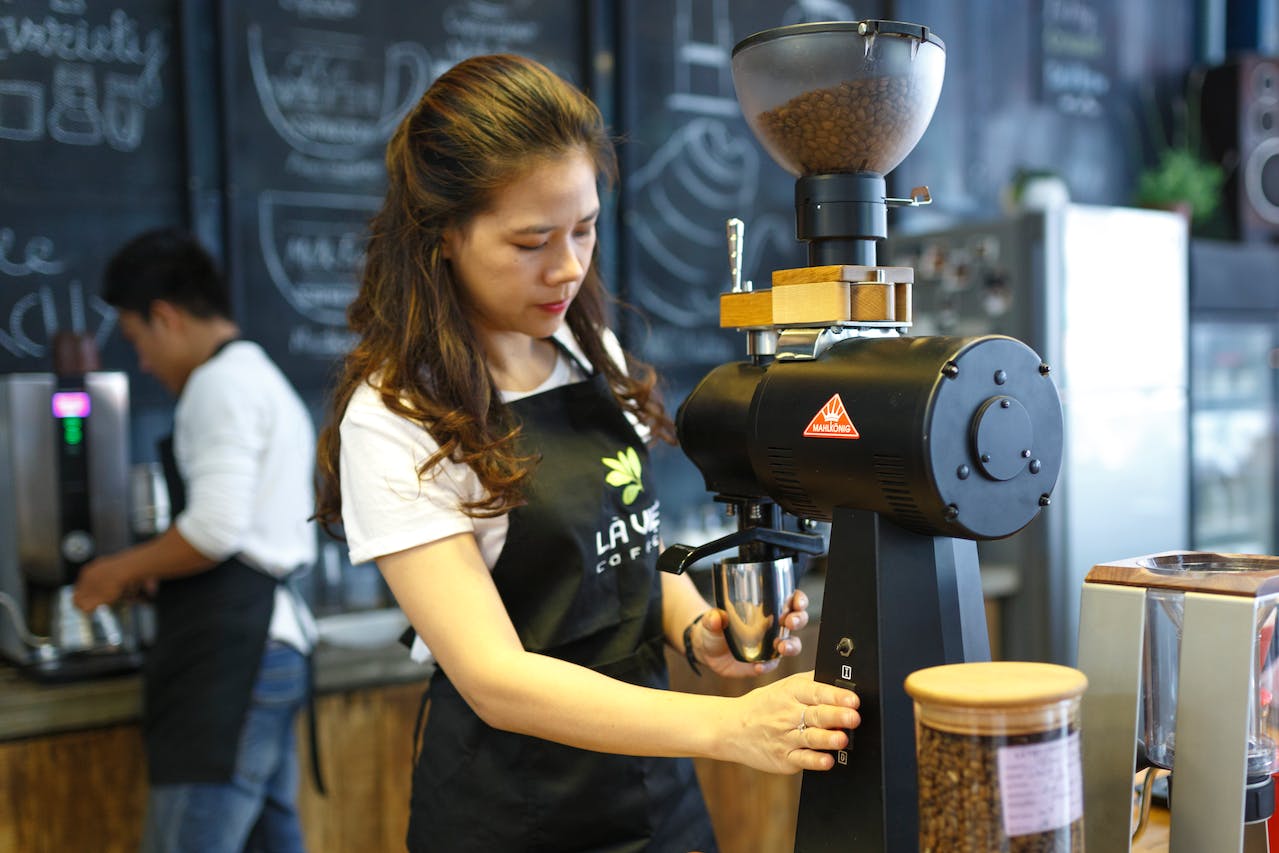 woman grinding coffee bean